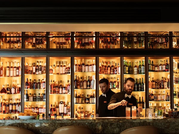 a bartender preparing drinks at Evolve Spirits Bar, Hobart
