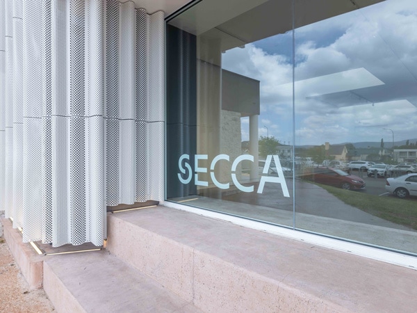 SECCA letters painted on the glass wall