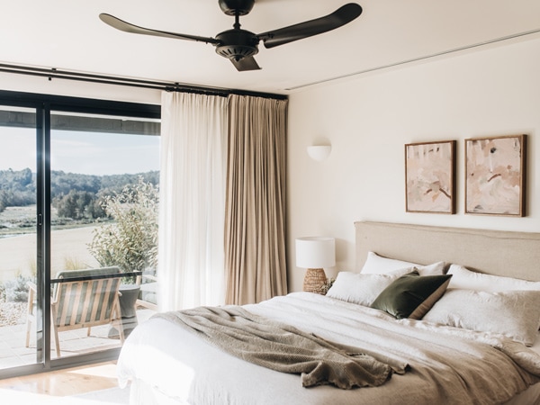 a bedroom with a sliding door and balcony at The Oaks Ranch, Batemans Bay
