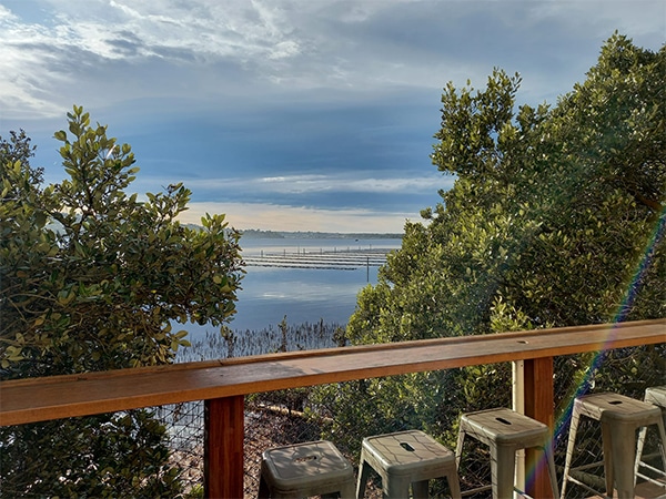 Outdoor deck for dining overlooking oyster leases in Merimbula