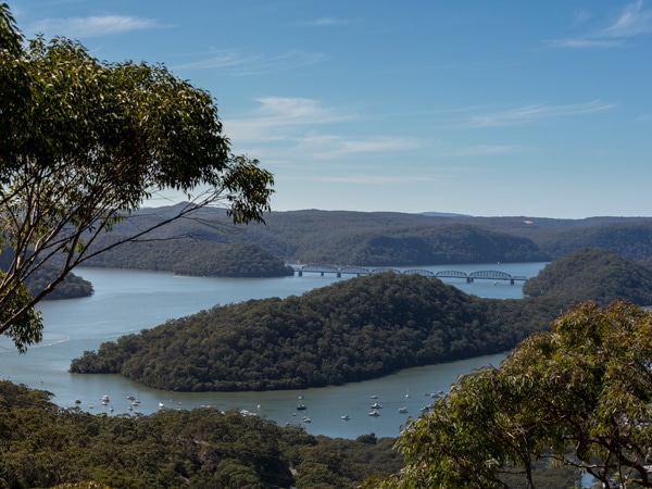 The view overlooking the Hawkesbury River A woman coming out of a tent in the Glenworth Valley camping grounds in Central Coast, Australia