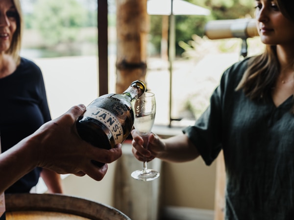 Wine being poured at Jansz Vineyard in Launceston, Tasmania, Australia