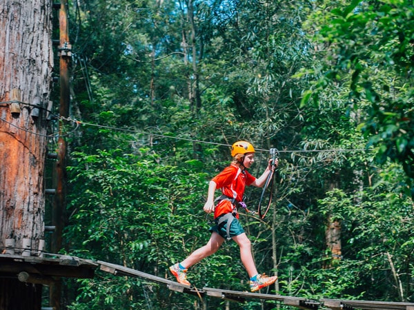 A kid about to zipline at Treetops Adventure Park in Central Coast, Australia
