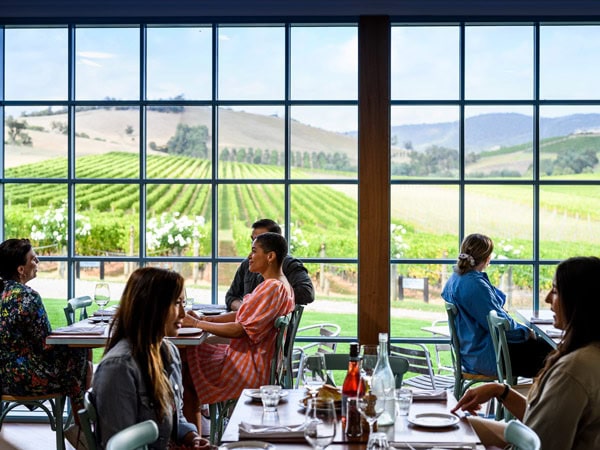 people dining at Soumah with vineyard views