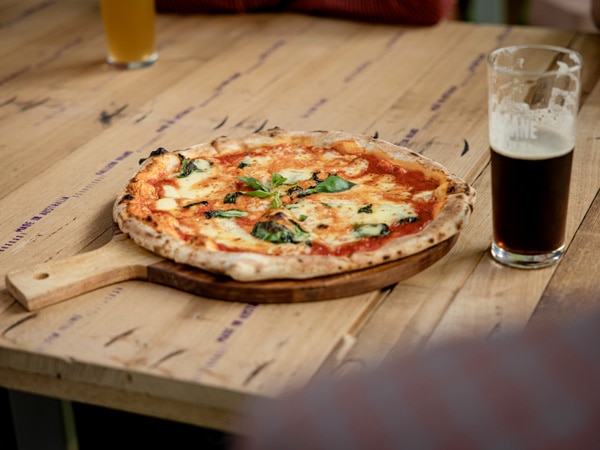 Pizza and dark lager at Du Cane in Launceston.