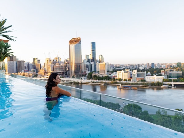 a woman at the edge of the pool at Emporium Hotel South Bank