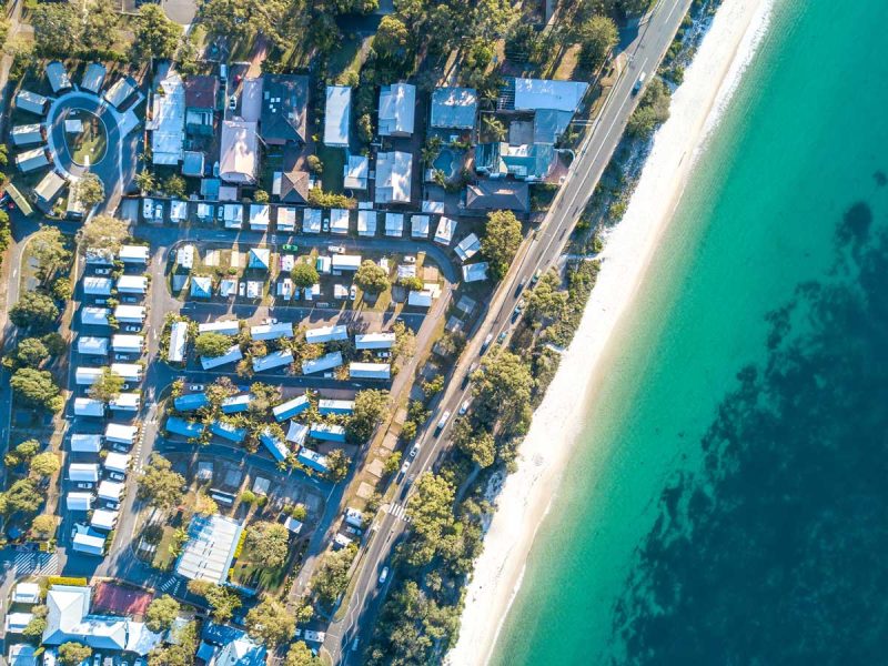 Aerial shot of Shoal Bay Holiday Park and Shoal Bay.
