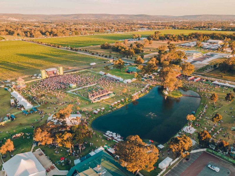 Drone shot of Wine Machine overlooking pond, stage and stalls.