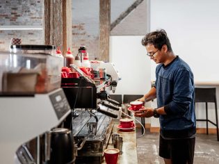 Barista making coffee at Bread + Butter Launceston