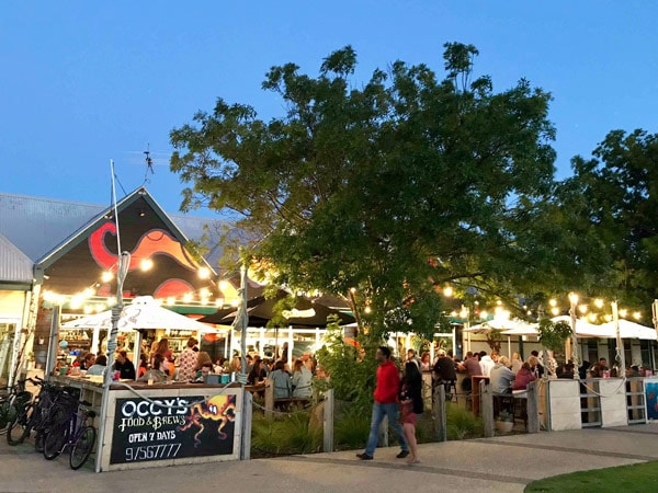 A restaurant at night with lights and people.