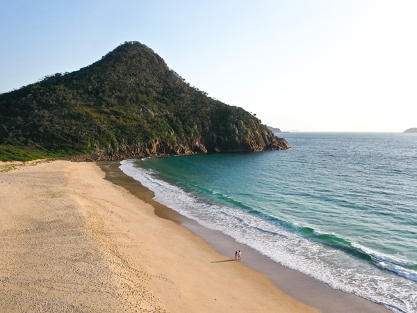 Shot of a couple walking on Zenith Beach.