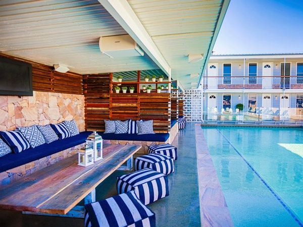 the pool area with shaded sofas at Rambutan, Townsville