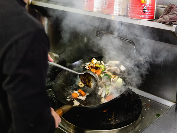 sauteing veggies in a pan at Mod Thai