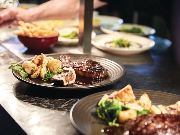 A layout of steak dishes at Marble & Grain in Canberra.