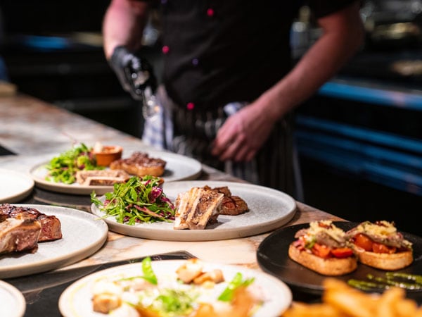 Chef serves food at Crystalbrook Bailey in Cairns