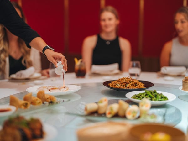 A waitress serves food to a table at Uncle Su on the Gold Coast.