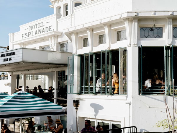 The exterior of Hotel Esplanade in St Kilda, with a view through the windows to inside
