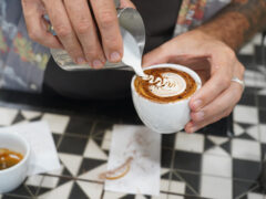 Pouring milk over coffee at Ray’s Patisserie and Cafe, Darwin