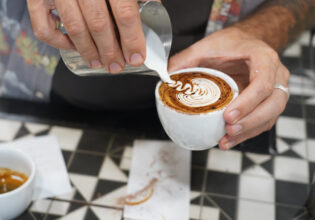 Pouring milk over coffee at Ray’s Patisserie and Cafe, Darwin