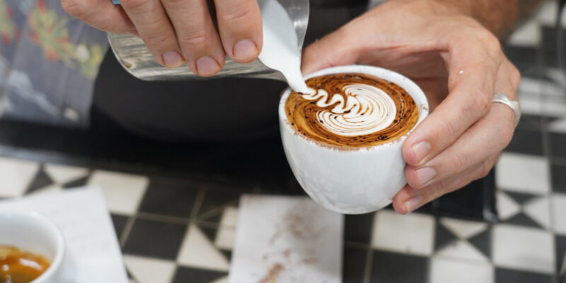 Pouring milk over coffee at Ray’s Patisserie and Cafe, Darwin