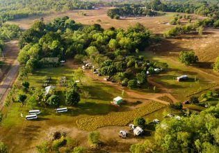 aerial shot of caravans dotting the verdant greenery at Litchfield Tourist Park in Darwin