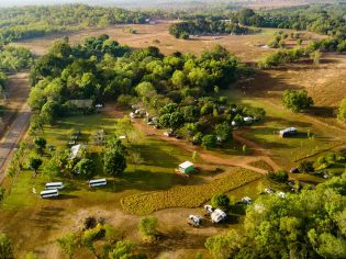 aerial shot of caravans dotting the verdant greenery at Litchfield Tourist Park in Darwin