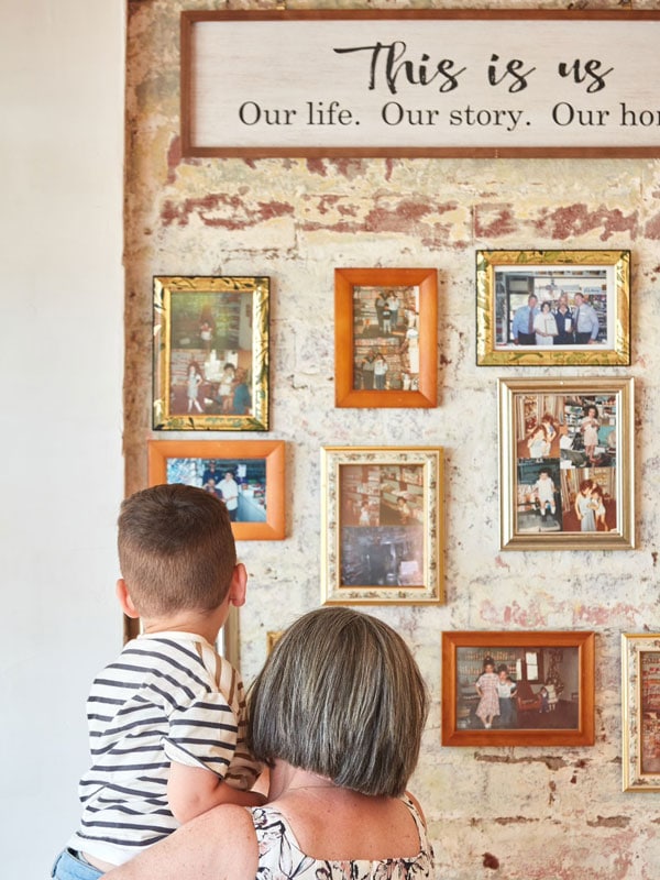 a mother and child looking at the photo gallery inside Emil’s Cafe in Pascoe Vale South