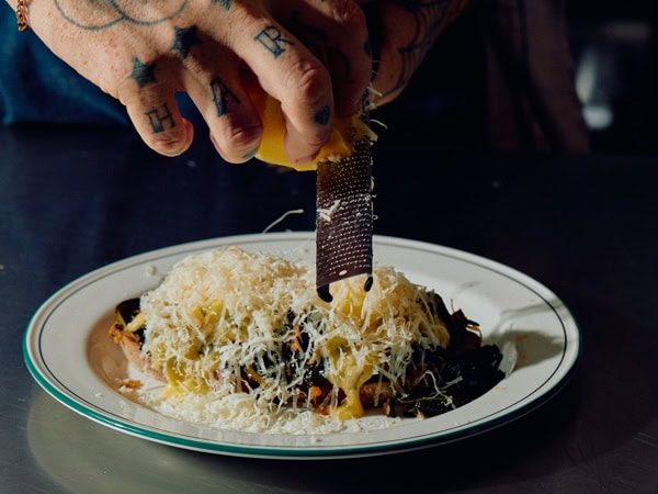 grating cheese into a dish at Florian Eatery, Carlton North