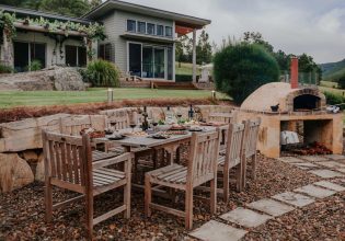 Outdoor dining area and woodfired oven in Yarramalong