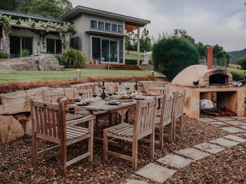 Outdoor dining area and woodfired oven in Yarramalong