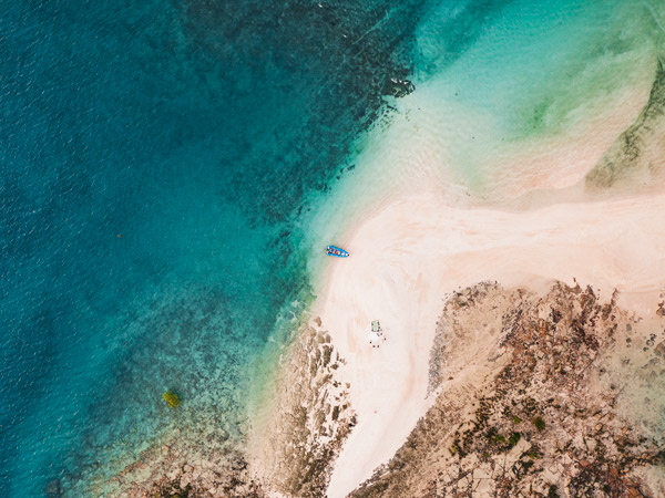 Aerial shot of boat on beach.