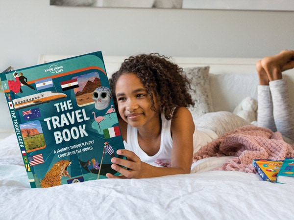 a kid reading the Lonely Planet Kids The Travel Book