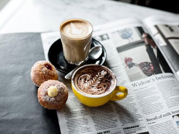 bread and coffee on newspaper at Noisette, Port Melbourne