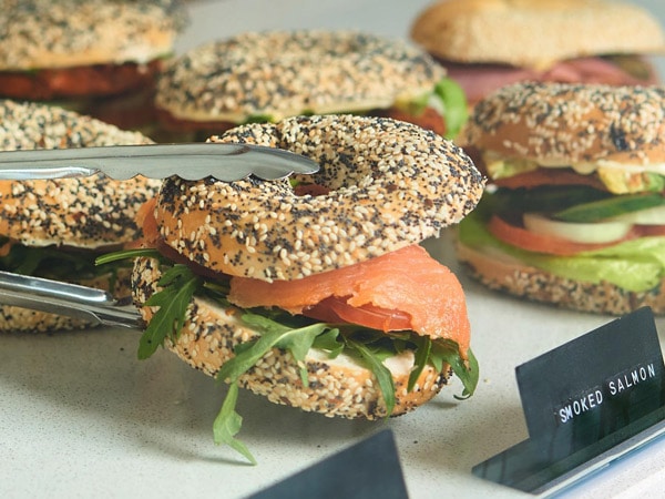 A bagel with salmon and lettuce.