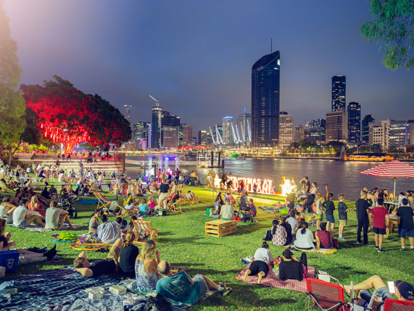 people having picnic at night on South Bank’s River Quay Green, Brisbane