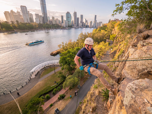 a man climbing the Kangaroo Point Cliffs with Riverlife Brisbane’s Day Rock Climb Adventures