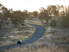 Car driving through the New England countryside in Uralla.