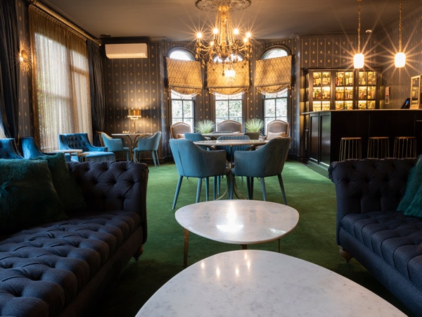 rich velvet armchairs at Aspinall’s Whisky Lounge