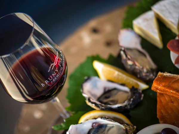 a glass of red wine and oysters at Bruny Island Premium Wines