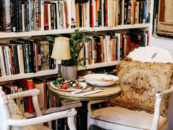 a dining setup next to a bookshelf at Harry’s on Green Lane, Bowral