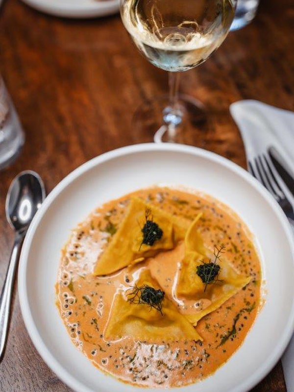 a plate of Parisian food at Herve’s Restaurant & Bar