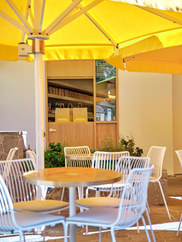 al fresco dining under yellow umbrellas at Sunshine Eatery, Brisbane