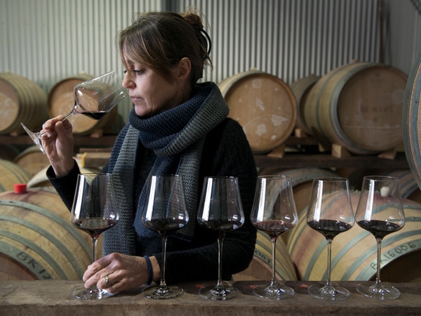 a woman sipping a glass of wine