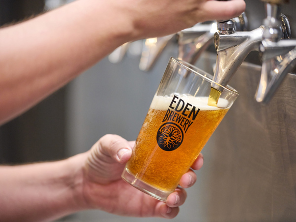 pouring tap beer into a glass at Eden Brewery