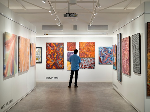 the paintings displayed on the wall inside the Gallery of Central Australia 