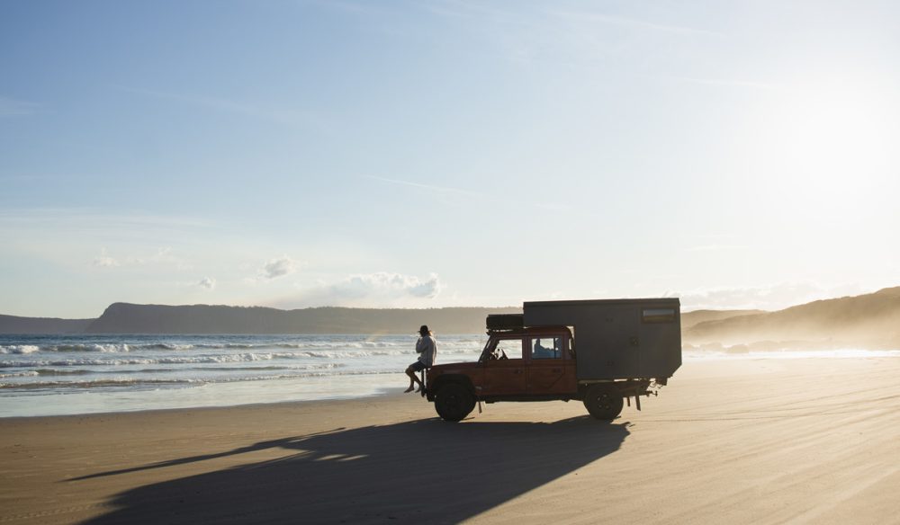 a person sitting on a 4WD vehicle on Cloudy Bay