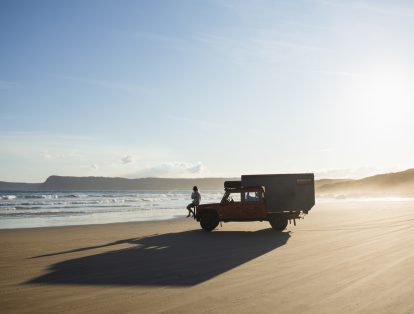 a person sitting on a 4WD vehicle on Cloudy Bay