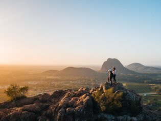 Standing at the top of Mount Ngungun at sunrise near Brisbane after hike