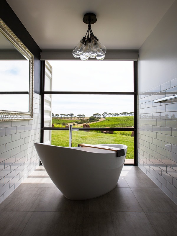 Huge bath looking out a large glass window at Hotel California Road in McLaren Vale. 