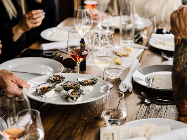 a plate of seafood with wine glasses on the table